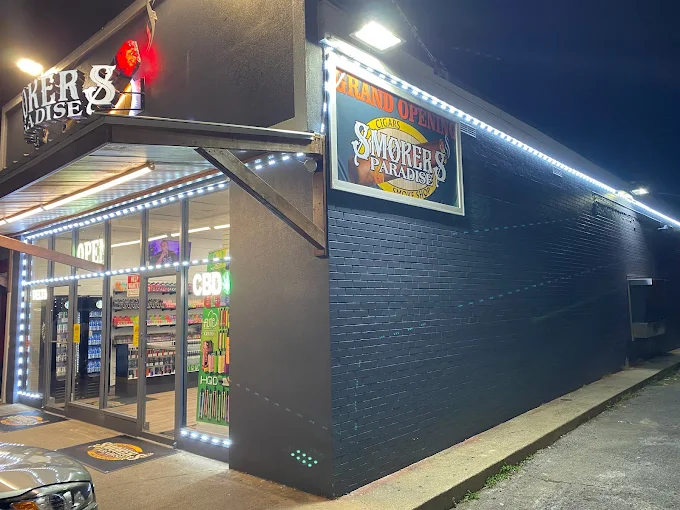 Smokers Paradise storefront at night